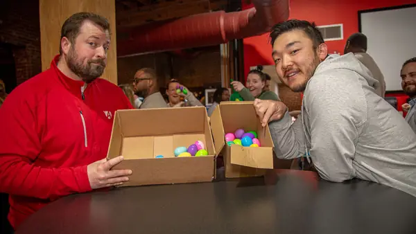 Team members with a box from the office Easter egg hunt