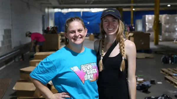 Two team members in Give Back Day shirts at a volunteer cleanup