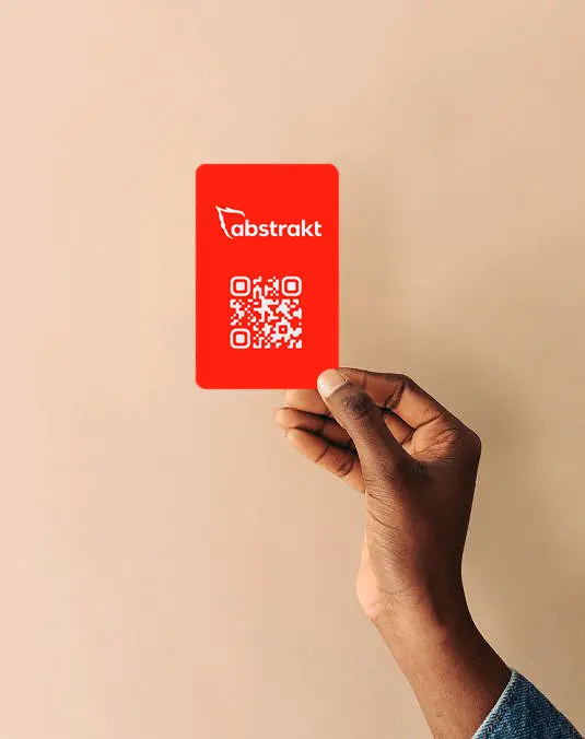 An Abstrakt Red Card with a QR code, held up in one hand