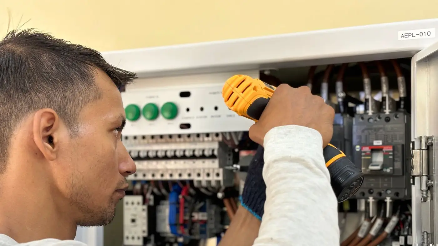 Electrician working in a breaker panel