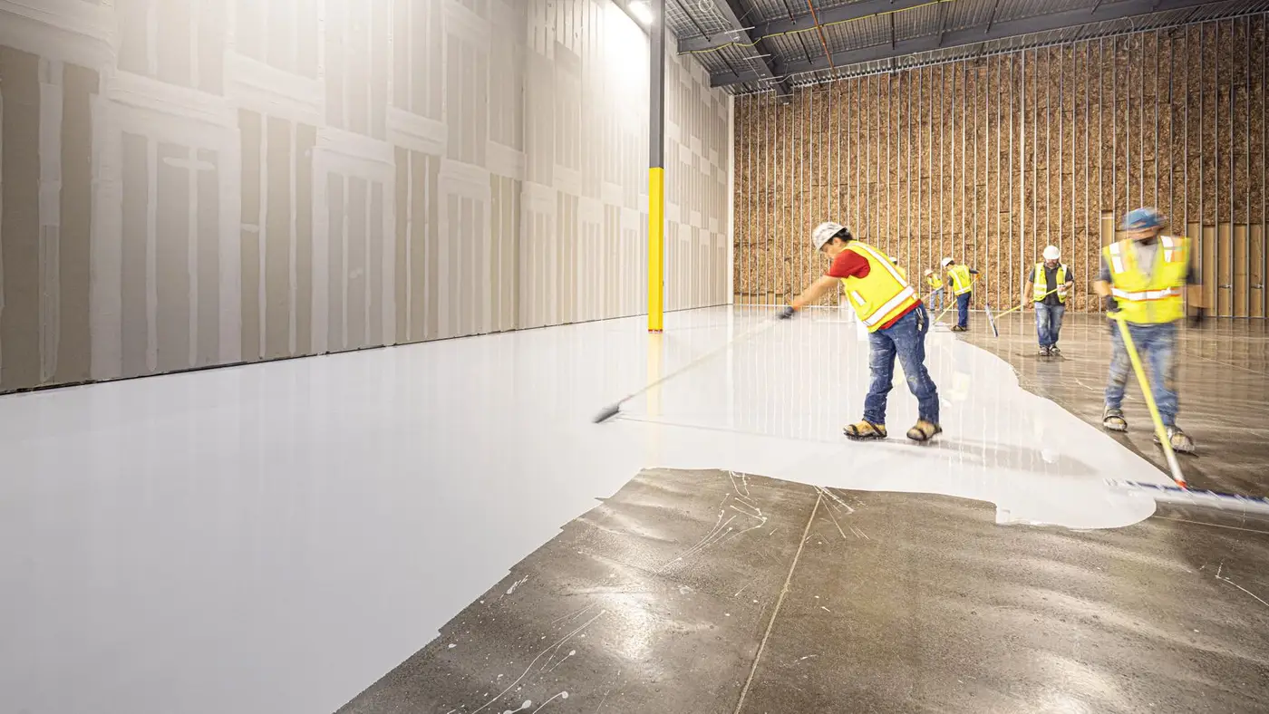 Crew finishing a new floor inside a commercial building